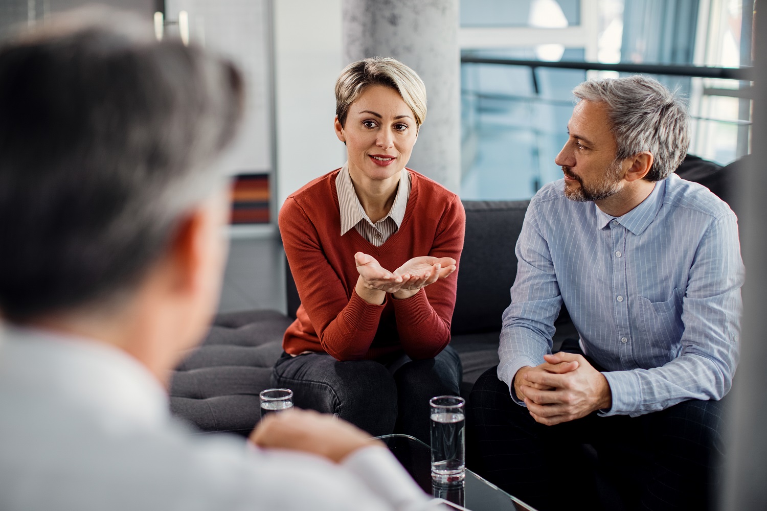 Mid adult couple talking to financial advisor during a meeting i